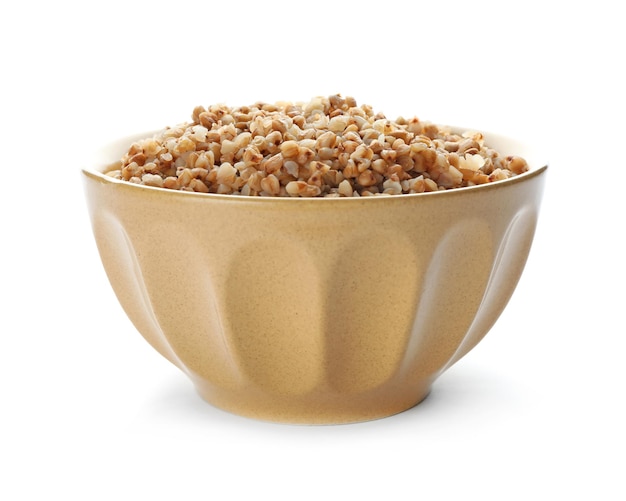 Bowl with cooked buckwheat on white background