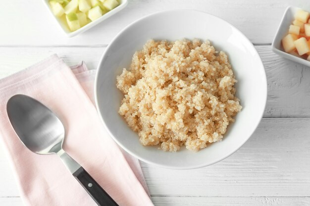 Photo bowl with cooked quinoa on kitchen table