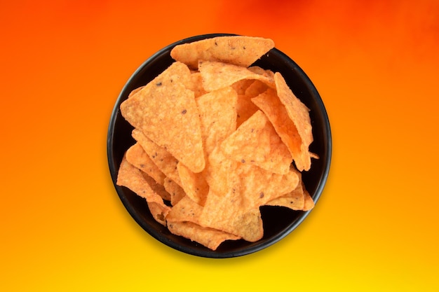 Bowl with crunchy cheese chips and colorful gradient background