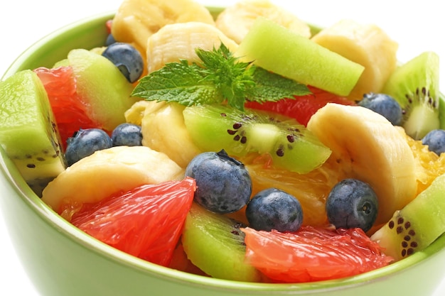 Bowl with delicious fruit salad closeup