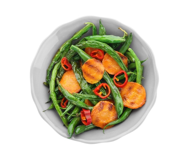 Bowl with delicious green beans pepper and carrot slices on white background