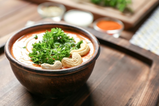 Bowl with delicious Murgh Makhani on table