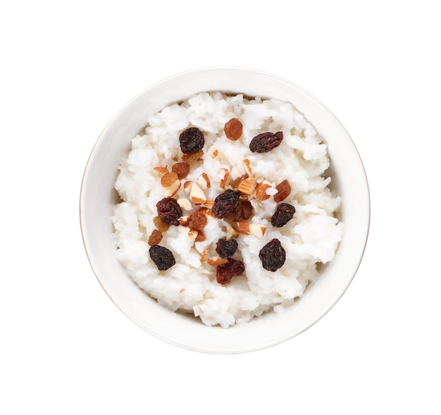 Bowl with delicious rice pudding, nuts and raisins on white