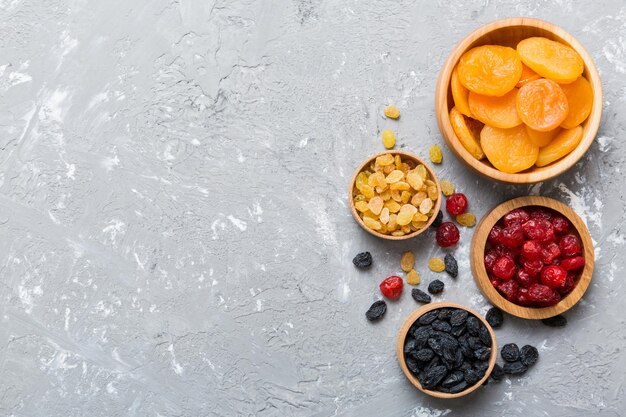 Bowl with different dried fruits on table background top view Healthy lifestyle with copy space