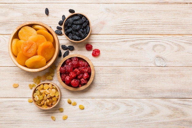 Bowl with different dried fruits on table background top view Healthy lifestyle with copy space