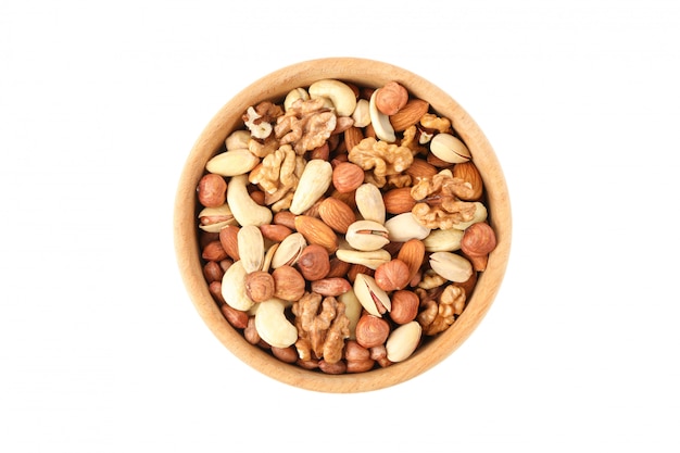 Bowl with different nuts isolated on white background. Vitamin food