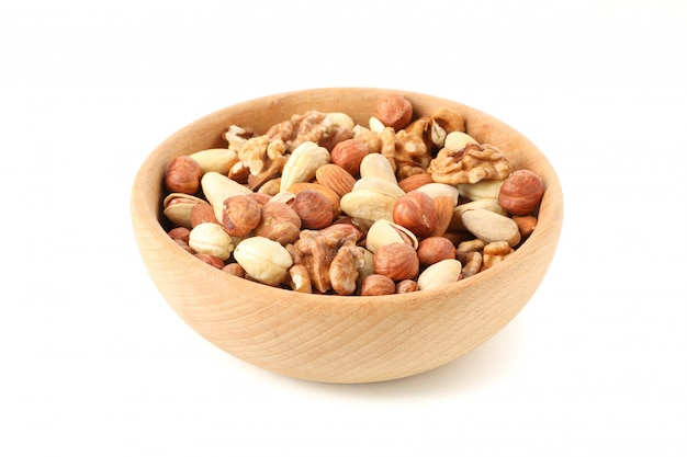 Bowl with different nuts isolated on white background