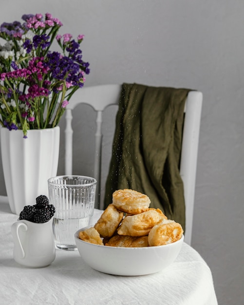 Bowl with donuts on table