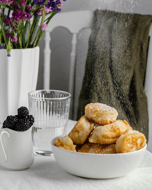 Bowl with donuts on table