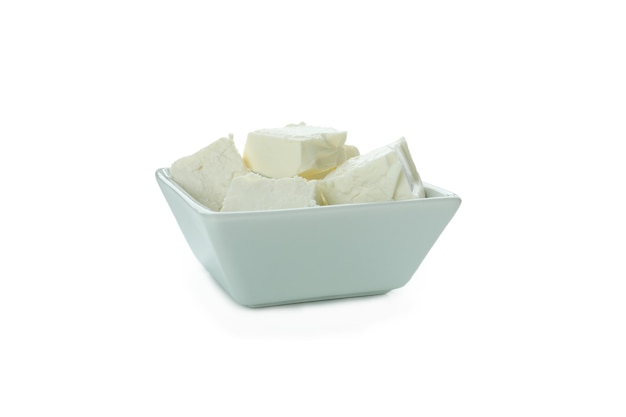 Bowl with feta cheese pieces isolated on white surface