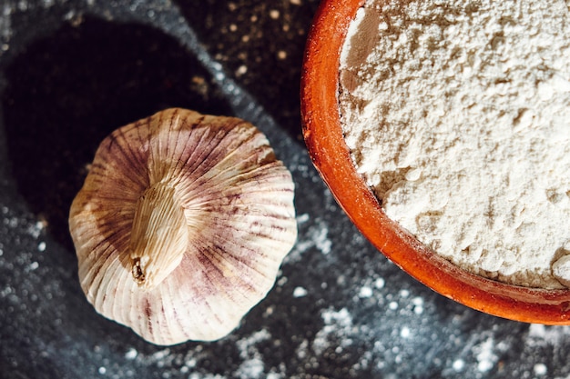 Bowl with flour and garlic