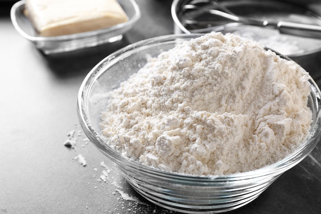 Bowl with flour on table