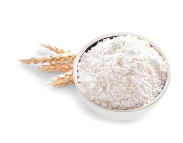 Bowl with flour on white background