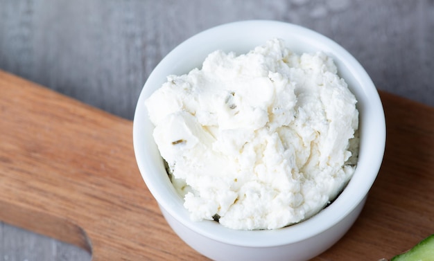 Bowl with fresh cottage cheese on tableBowl with fresh cottage cheese on table