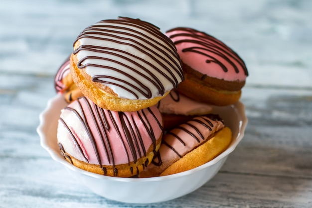 Bowl with glazed cookies. Sweets with decoration. Dish contains lots of sugar. Treats for gourmets.