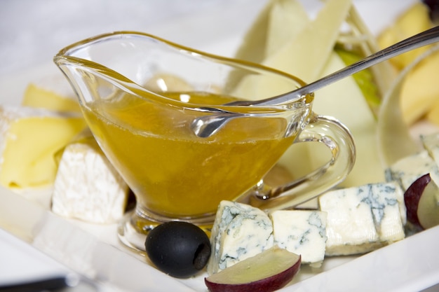 Bowl with honey and spoon on the table