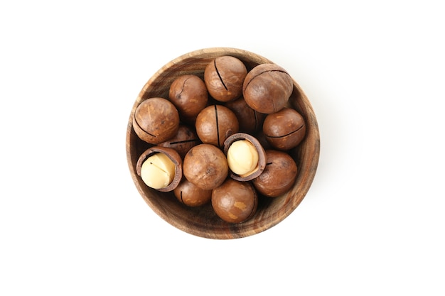 Bowl with macadamia nuts isolated on white