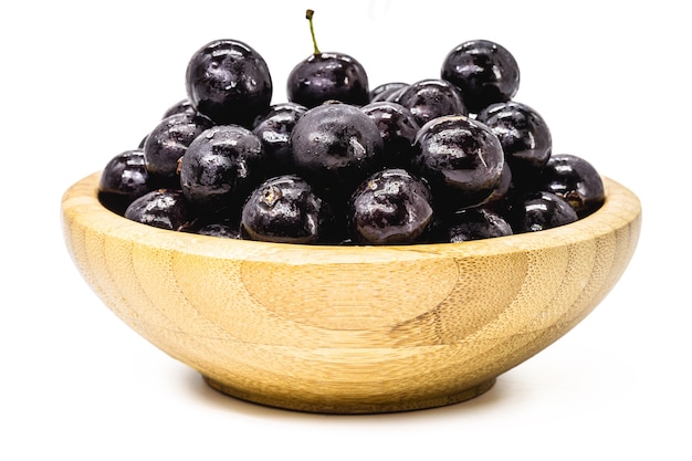 Bowl with many jabuticabas , isolated white background