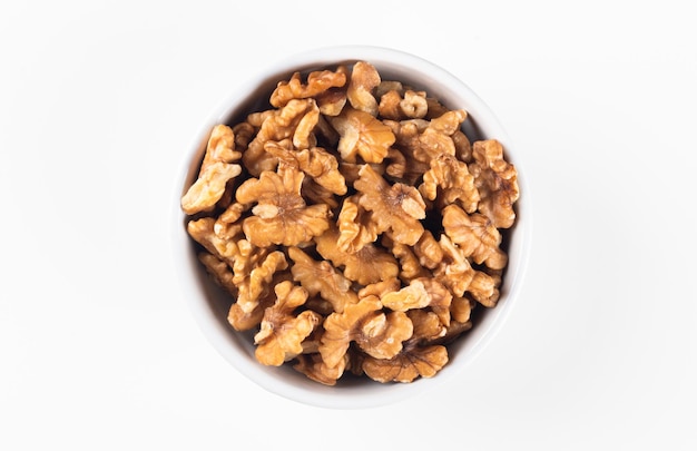 Bowl with nuts and white background top view