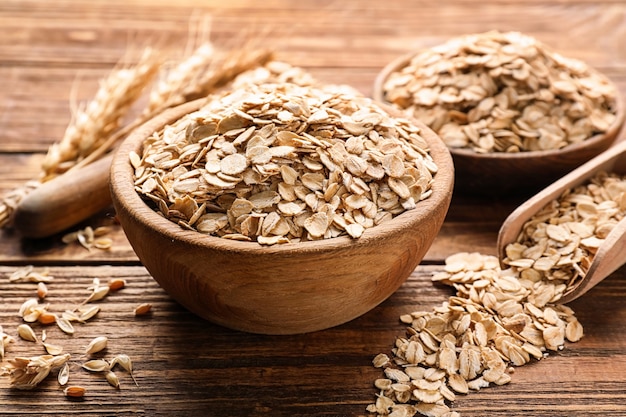 Bowl with oat flakes on wooden table