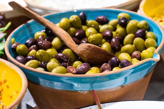 A bowl with olives in a self service cafe