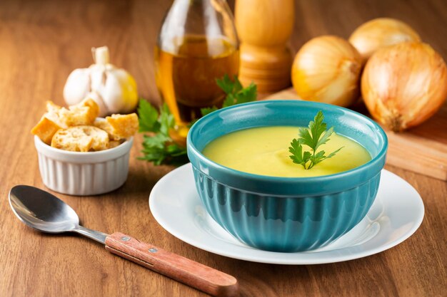 Bowl with onion soup and croutons on the table.