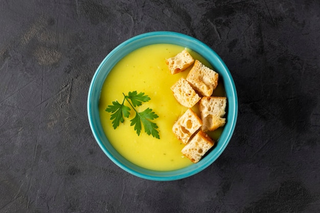 Bowl with onion soup and croutons on the table