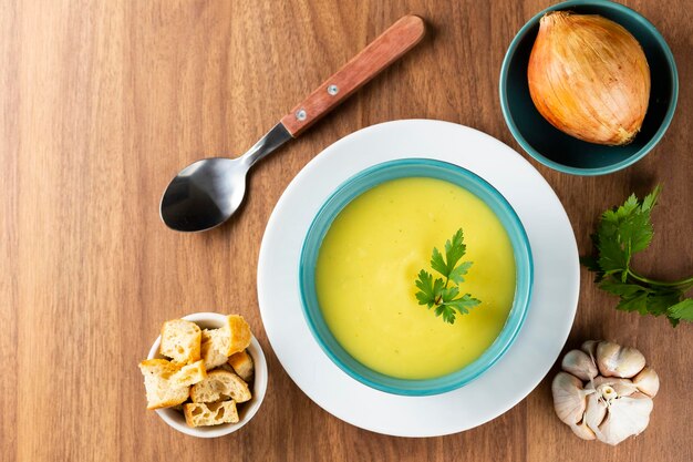 Bowl with onion soup and croutons on the table