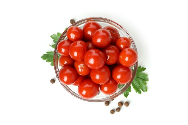 Bowl with pickled tomatoes isolated on white background