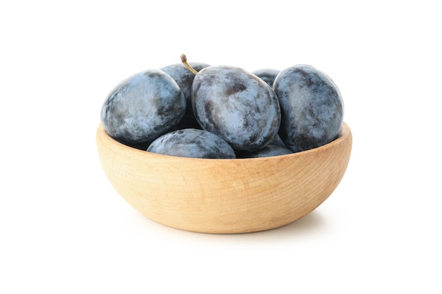 Bowl with plums isolated on white