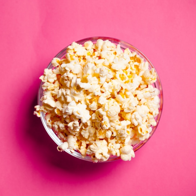 Bowl with popcorn on red 