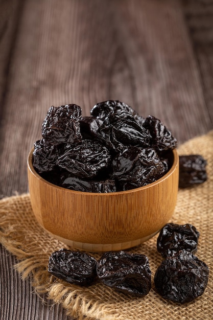 Bowl with prunes on the table