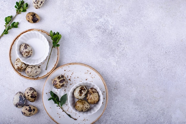 Bowl with quail eggs on light background