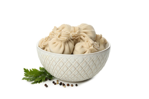 Bowl with raw khinkali isolated on white table