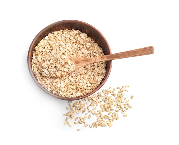 Bowl with raw oatmeal and spoon on white background