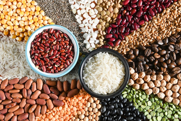 Bowl with raw white rices and beans on various seeds grain