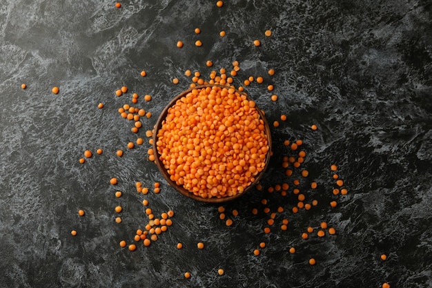 Bowl with red legumes on black smokey table