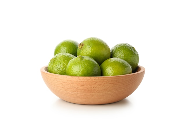 Bowl with ripe lime isolated on white background