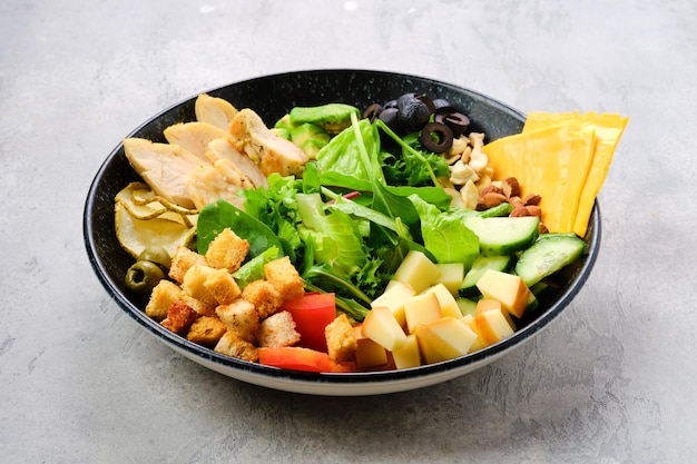 Bowl with salad mix and various snacks as a starter