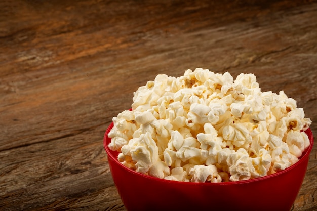 Bowl with salted popcorn sore the table