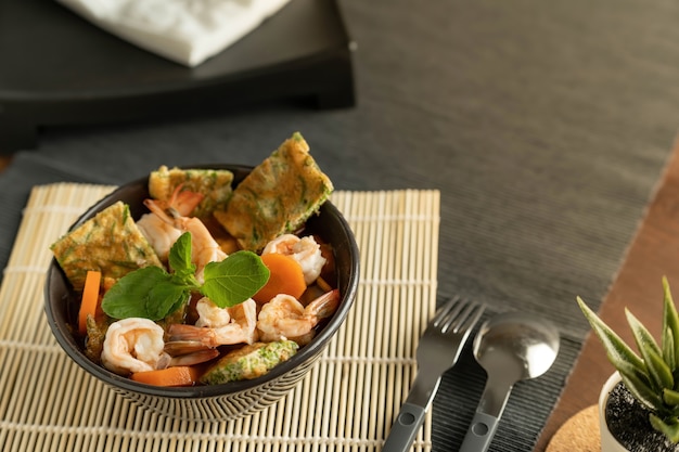 bowl with seafood salad on table