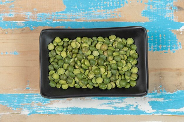 Bowl with soy beans on blue rustic wooden table