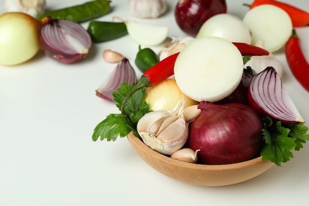 Bowl with spicy vegetables on white background