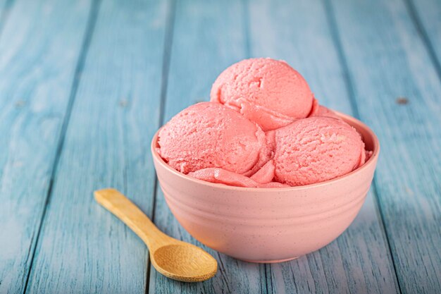 Bowl with strawberry ice cream balls.