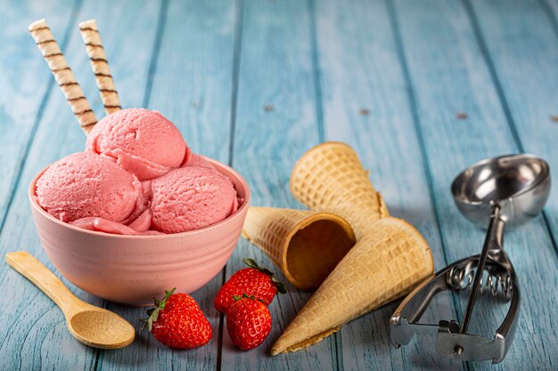 Bowl with strawberry ice cream balls.