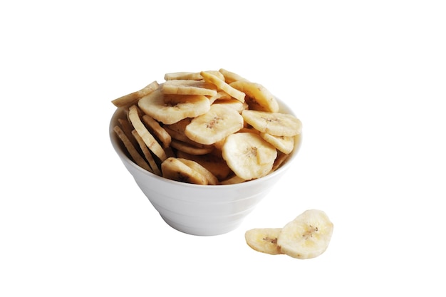 Bowl with sweet banana slices on white background, top view. Dried fruit as healthy snack