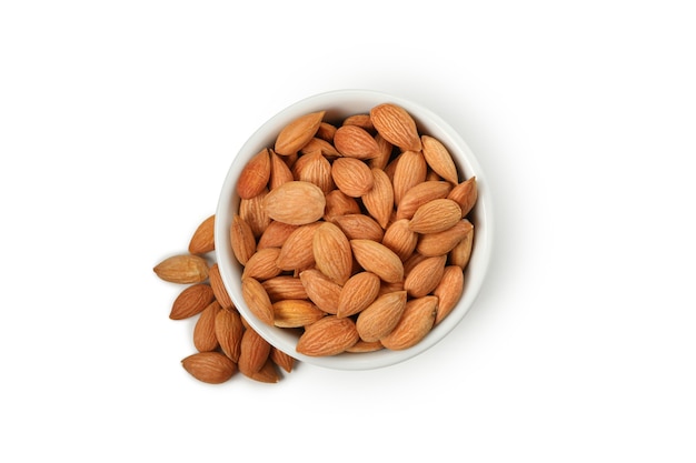 Bowl with tasty almond isolated on white wall