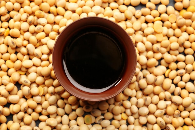 Bowl with tasty soy sauce and beans closeup