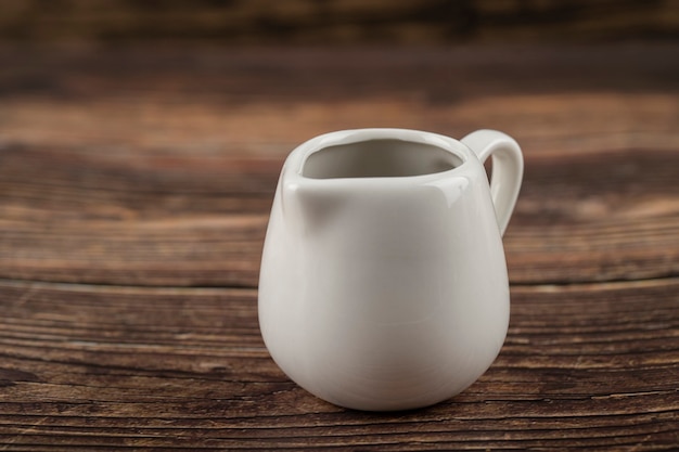 Bowl with tasty soy sauce placed on a wooden table.