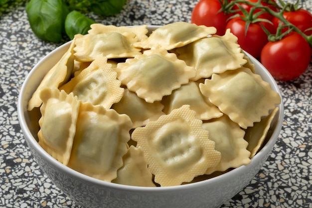 Bowl with traditional fresh Italian raviolini stuffed with Basilicum and Provolone